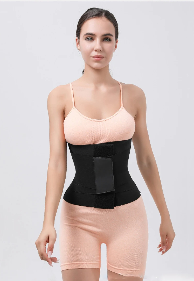 a woman wearing a pink bodysuit and a black waist trainer belt