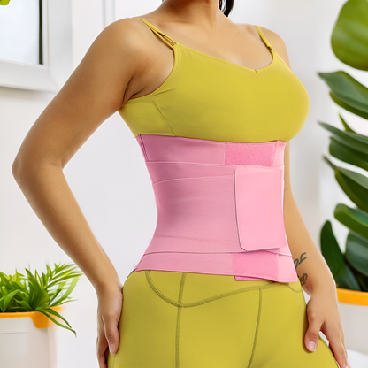 a woman wearing a yellow top and a pants with a pink waist trainer belt