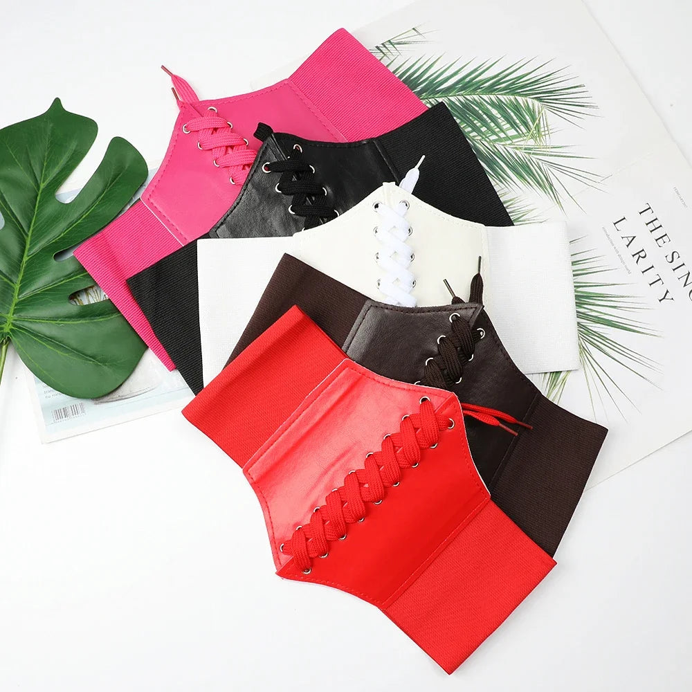 a group of four different colored leather corsets