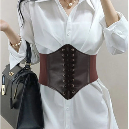 a woman wearing a white shirt and brown leather corset