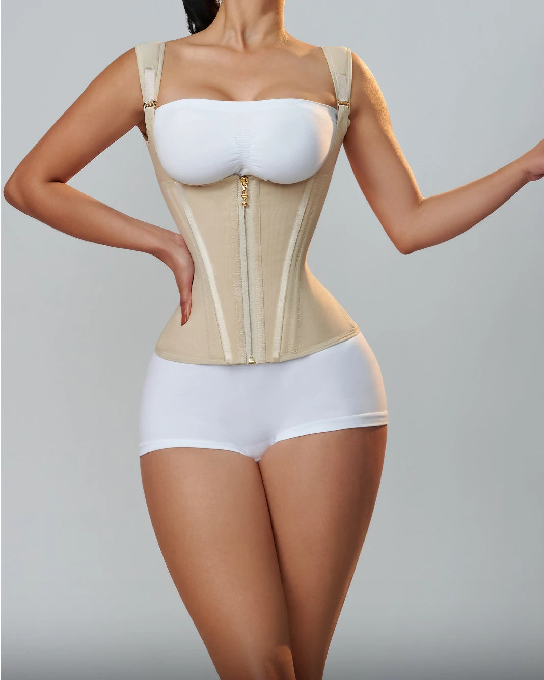 a woman wearing a beige Enviable Beauty fajas colombianas classic waist trainer with zippers